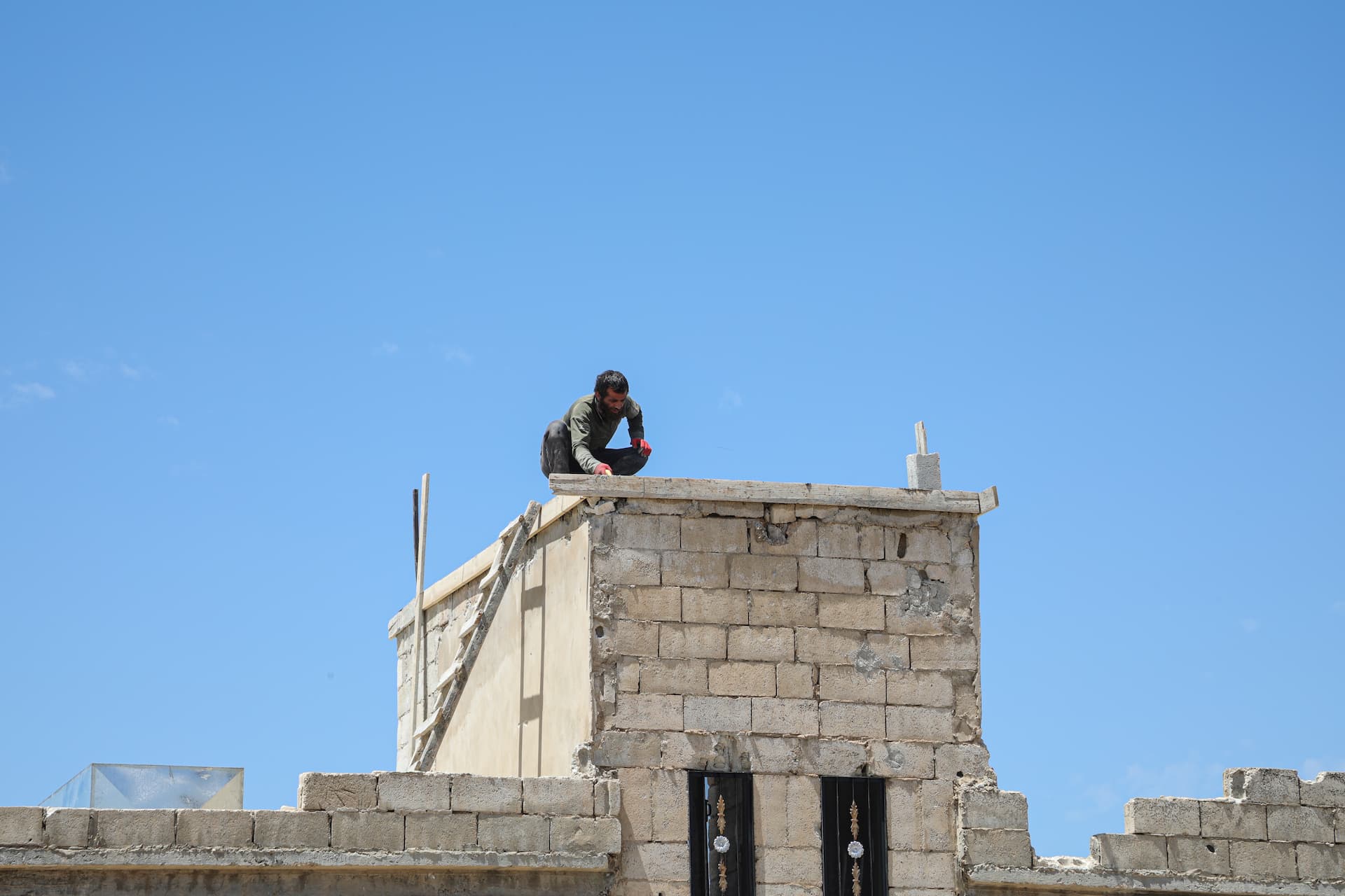 A worker repairs the rooftop of a returnee family’s home in southern rural Idlib as part of UNHCR’s cash-for-shelter project. The intervention addresses structural damage and helps ensure safer living conditions for families returning after years of displacement.