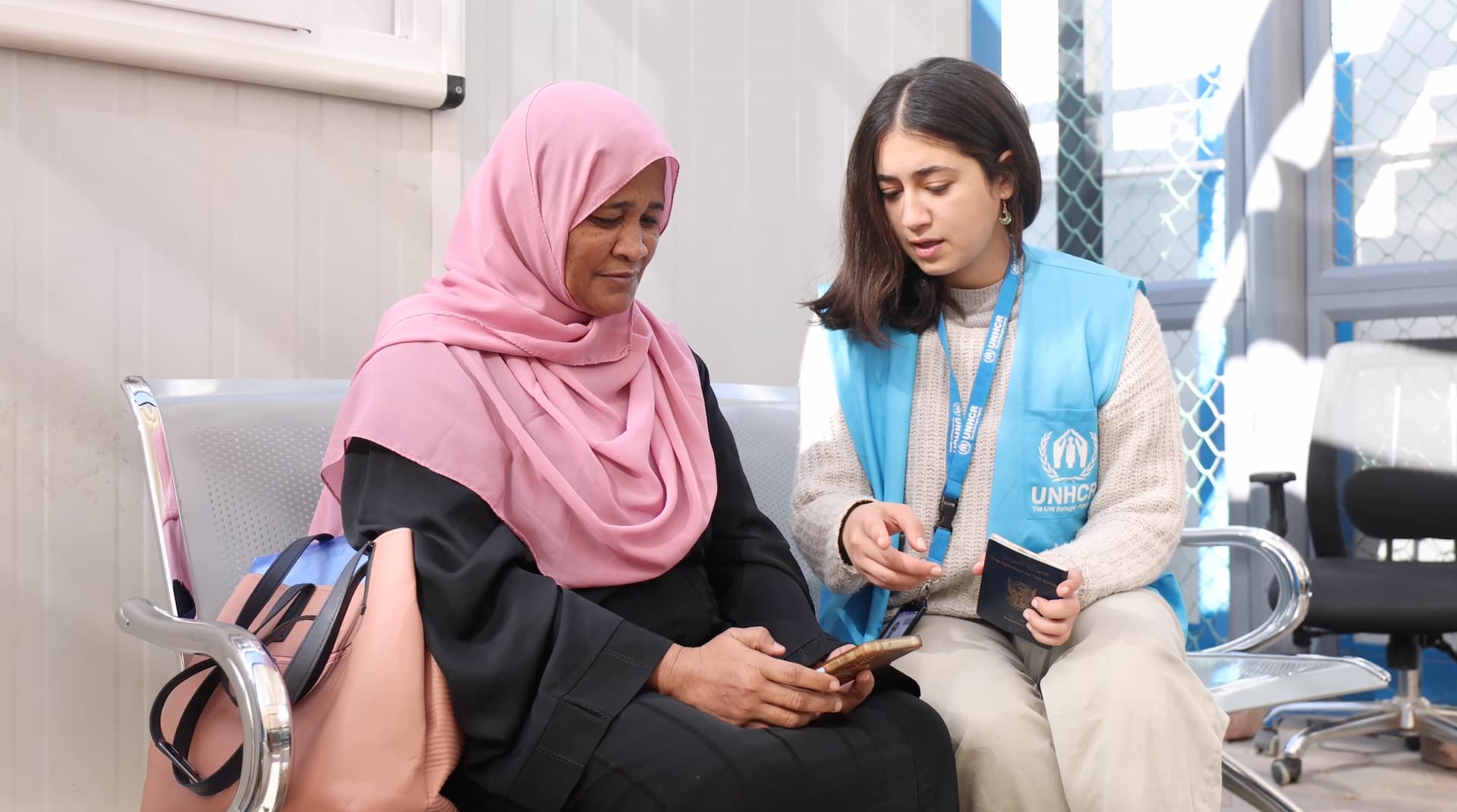One of the UNHCR staff testing the new onboarding tool with a Sudanese refugee in Egypt. This tool will enable new arrivals from Sudan to request a registration appointment with UNHCR on any digital device.