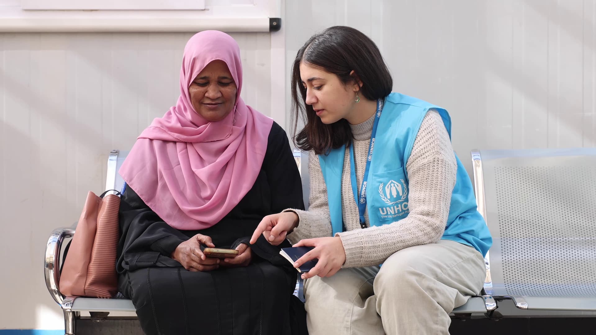 One of the UNHCR staff testing the new onboarding tool with a Sudanese refugee. This tool will enable new arrivals from Sudan to request a registration appointment with UNHCR on any digital device. © UNHCR/Pedro Costa Gomes