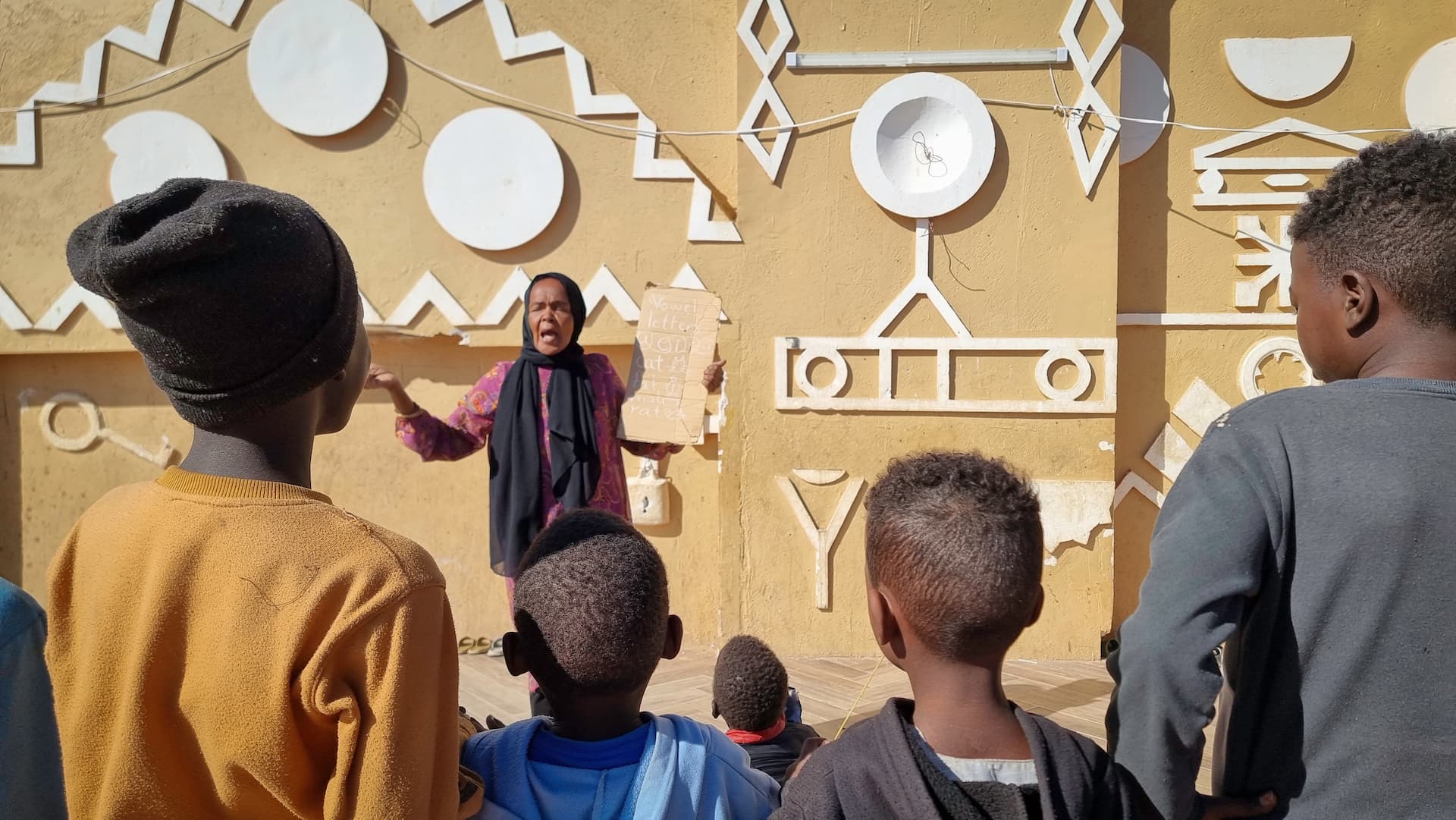 A displaced teacher gives an English class to children in a shelter for displaced families in Wadi Halfa, near Sudan’s border with Egypt.